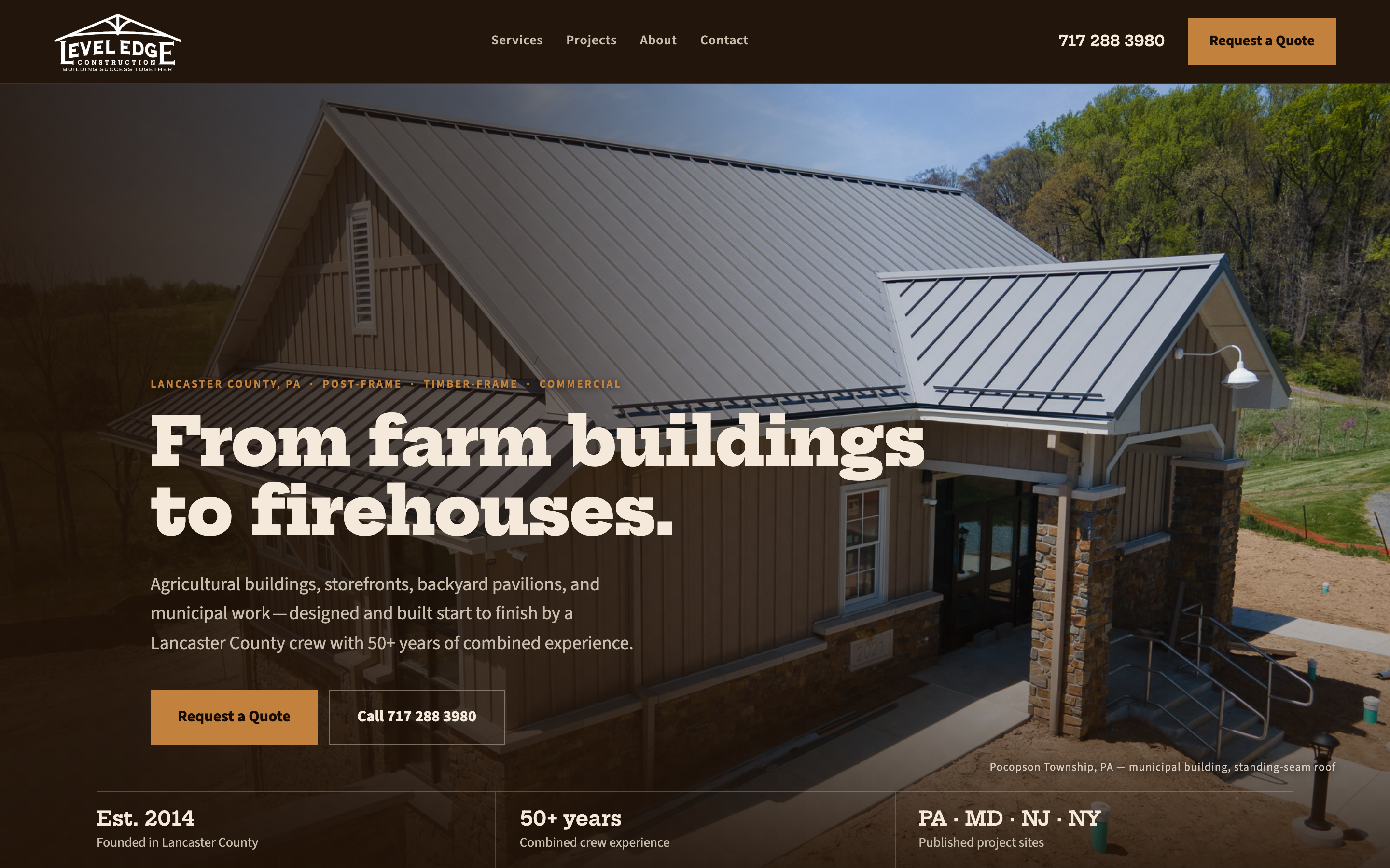 Level Edge Construction design concept — dark espresso hero with the Pocopson Township municipal building, headline 'From farm buildings to firehouses', and a proof strip